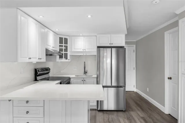 a kitchen with stainless steel appliances a refrigerator sink and microwave