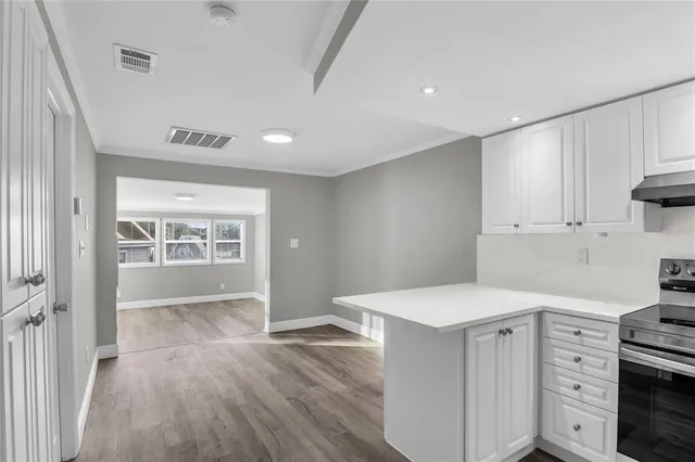 a kitchen with a wooden floor and white appliances