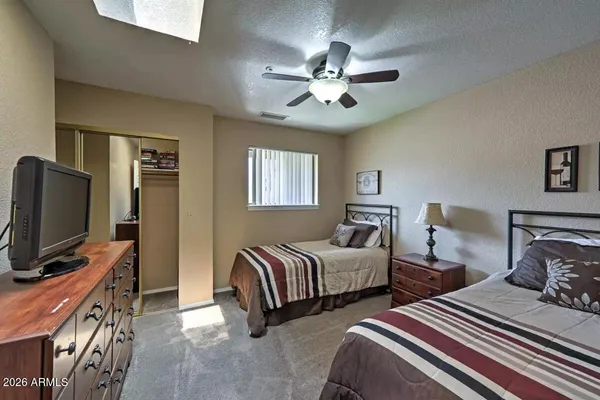 a bedroom with two beds and a flat screen tv