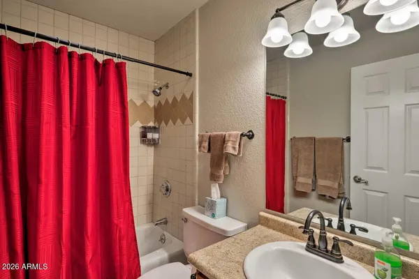 a bathroom with a double vanity sink mirror and shower