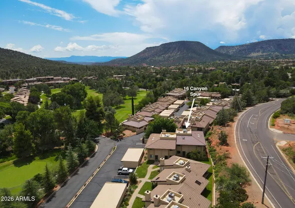 an aerial view of residential houses with outdoor space