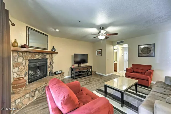a living room with furniture a fireplace and a flat screen tv