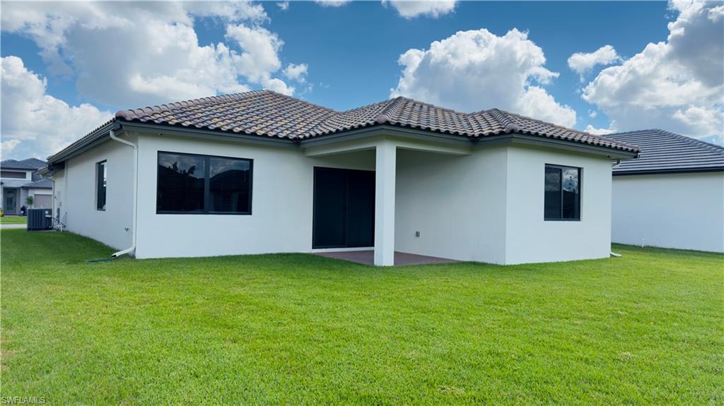5089 Panella Avenue Ave Maria, FL 34142 - Photo 17 of 46 a front view of a house with garden