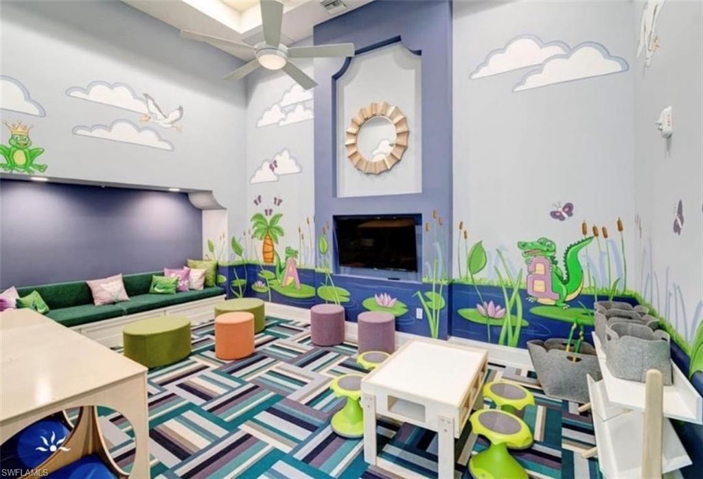 5089 Panella Avenue Ave Maria, FL 34142 - Photo 23 of 46 a living room filled with furniture and a fireplace