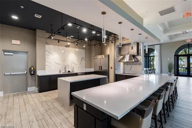 an open kitchen with a dining table chairs and chandelier