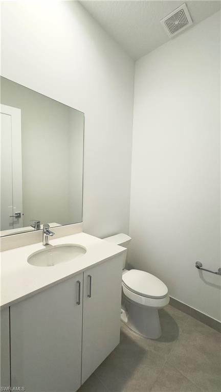 5089 Panella Avenue Ave Maria, FL 34142 - Photo 3 of 46 a bathroom with a sink a toilet and mirror