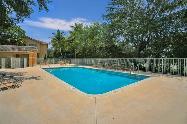 a view of a swimming pool with a yard