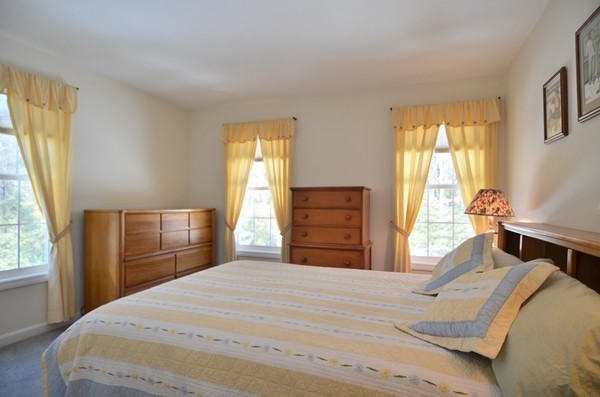 376 Mulpus Road Lunenburg, MA 01462 - Photo 18 of 27 a bedroom with a bed and wooden floor
