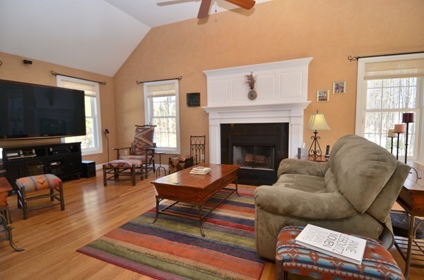376 Mulpus Road Lunenburg, MA 01462 - Photo 7 of 27 a living room with furniture a flat screen tv and a fireplace
