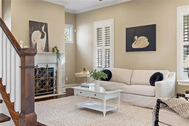 a living room with furniture a rug and a window