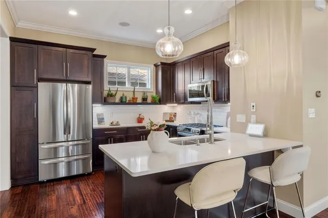 a kitchen with refrigerator cabinets dining table and chairs