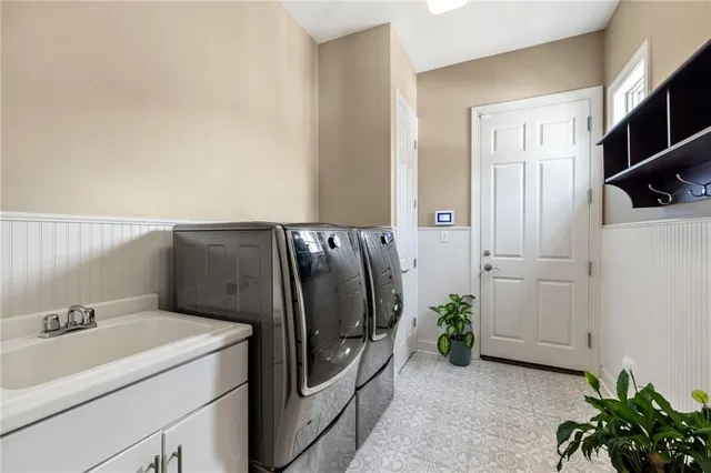 a view of a storage and utility room with washer and dryer