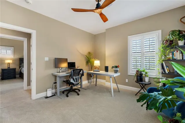 a view of a livingroom with workspace and a window