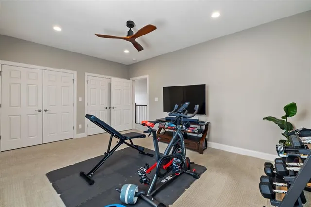 a living room with furniture a flat screen tv and a window