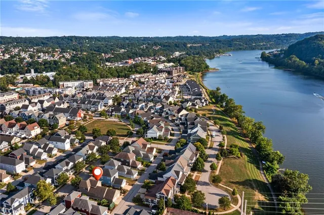 an aerial view of residential building and lake
