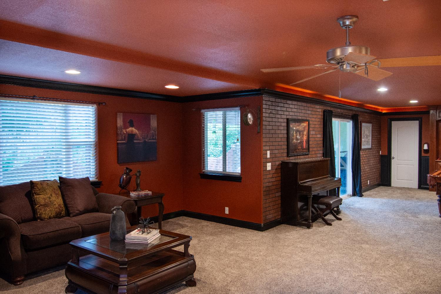 3388 Sudbury Road Cameron Park, CA 95682 - Photo 27 of 55 a living room with furniture and a chandelier