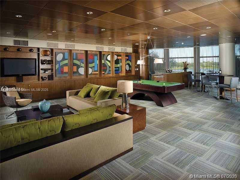 2641 North Flamingo Road, Unit 2307N Sunrise, FL 33323 - Photo 13 of 43 a living room with furniture and a flat screen tv