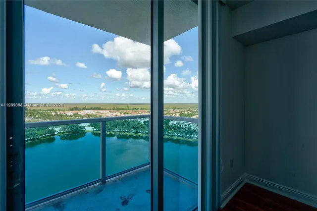 a view of a glass door with a lake view