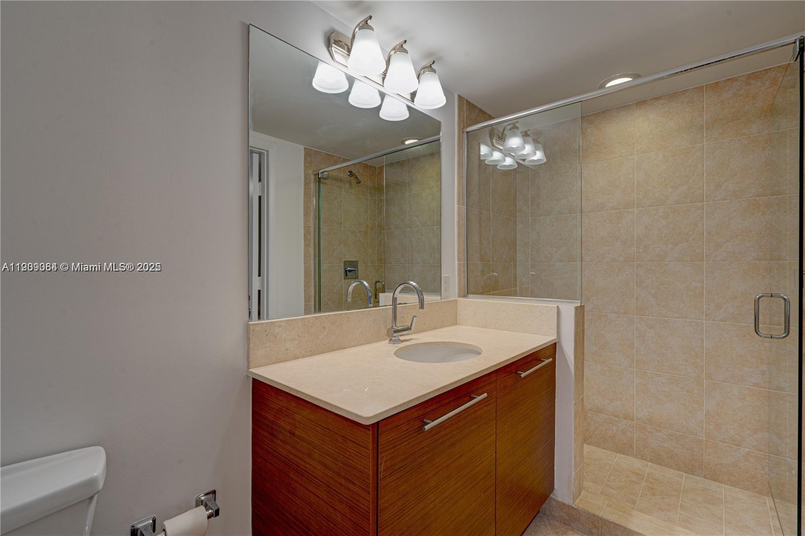 2641 North Flamingo Road, Unit 2307N Sunrise, FL 33323 - Photo 22 of 43 a bathroom with a sink and a mirror