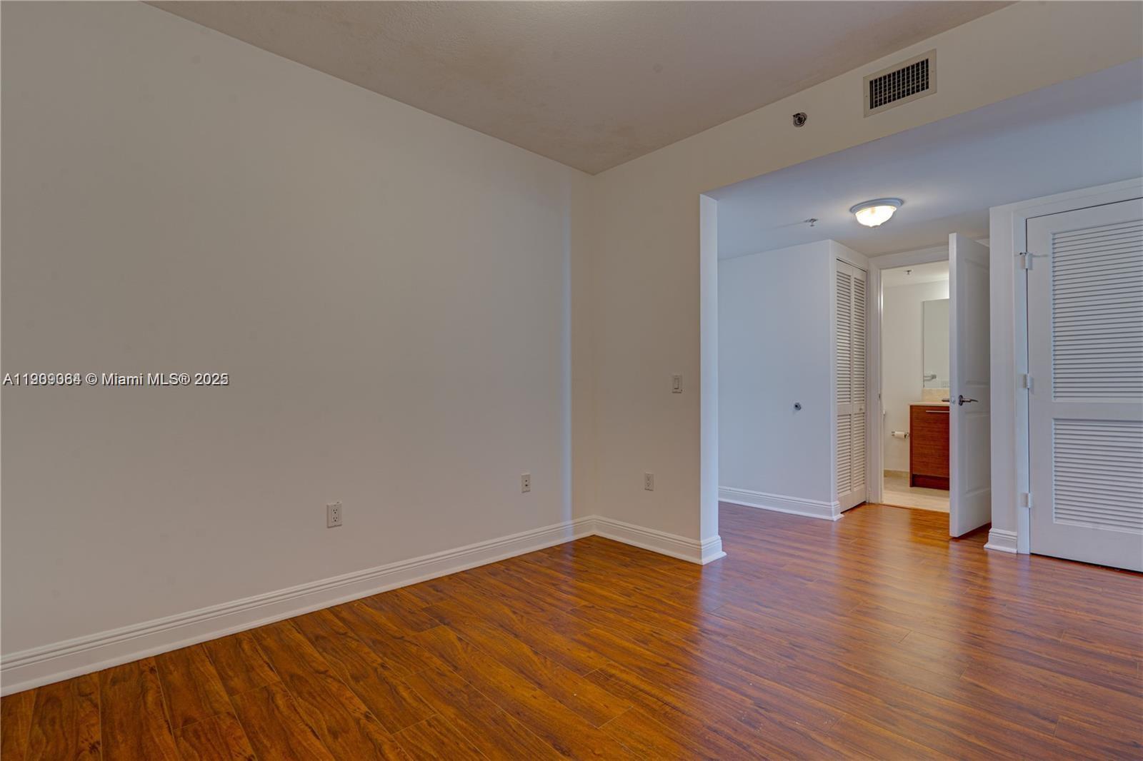2641 North Flamingo Road, Unit 2307N Sunrise, FL 33323 - Photo 24 of 43 a view of an empty room with wooden floor