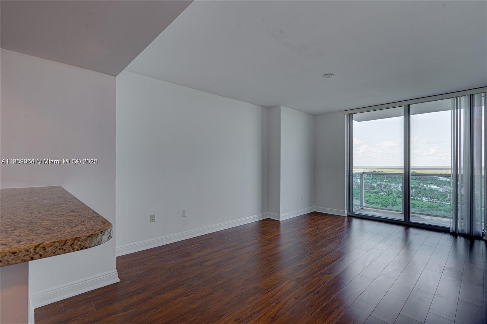 2641 North Flamingo Road, Unit 2307N Sunrise, FL 33323 - Photo 31 of 43 wooden floor in an empty room with a window