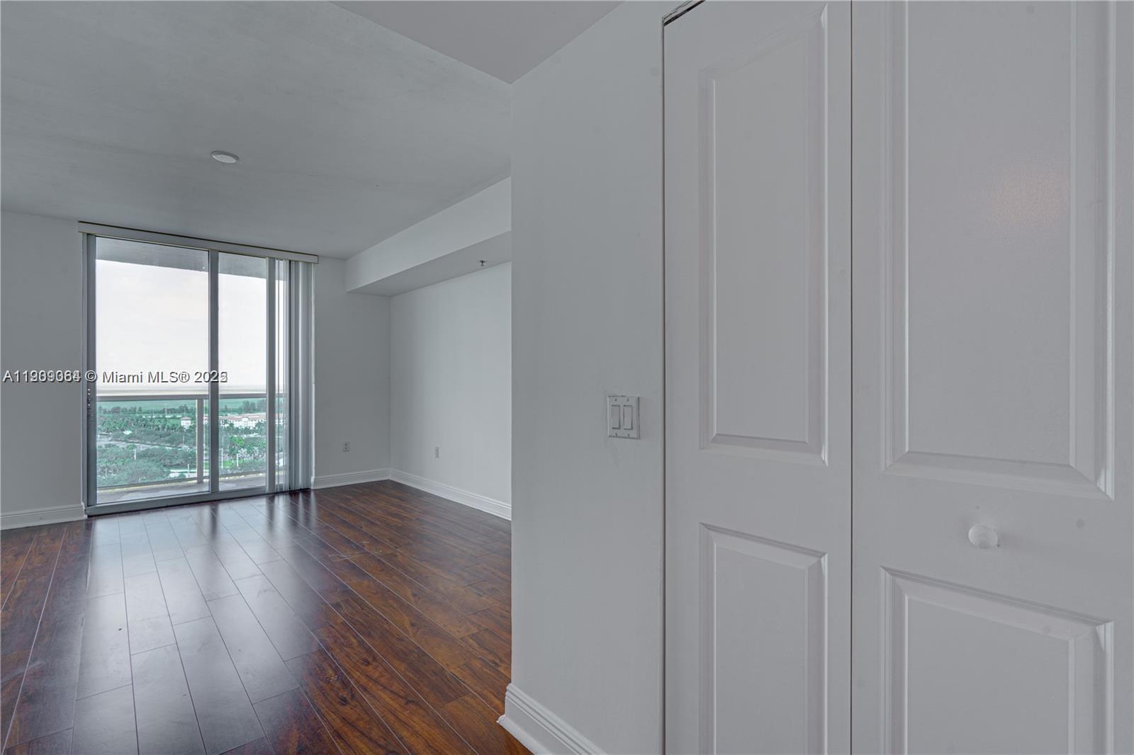 2641 North Flamingo Road, Unit 2307N Sunrise, FL 33323 - Photo 34 of 43 a view of an empty room with wooden floor and a window