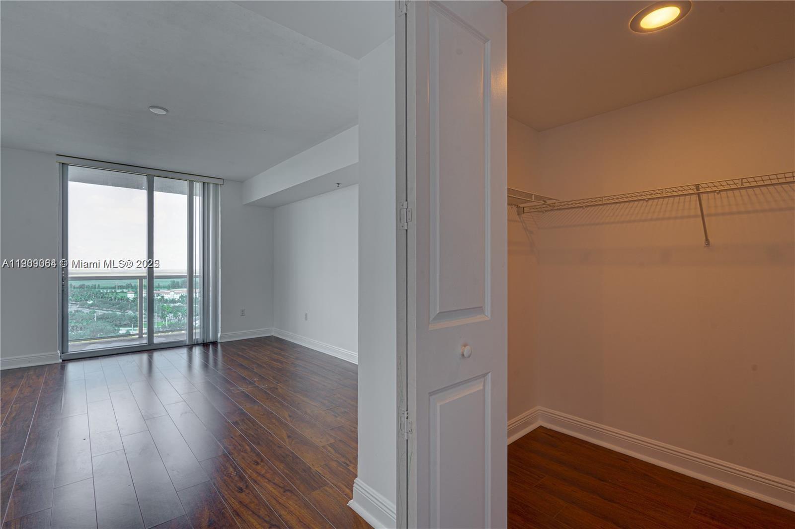 2641 North Flamingo Road, Unit 2307N Sunrise, FL 33323 - Photo 35 of 43 a view of an empty room with wooden floor and a window