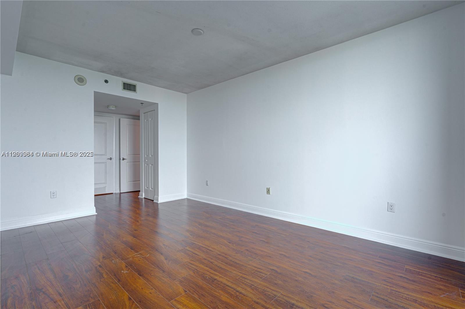 2641 North Flamingo Road, Unit 2307N Sunrise, FL 33323 - Photo 37 of 43 a view of an empty room with wooden floor and a window