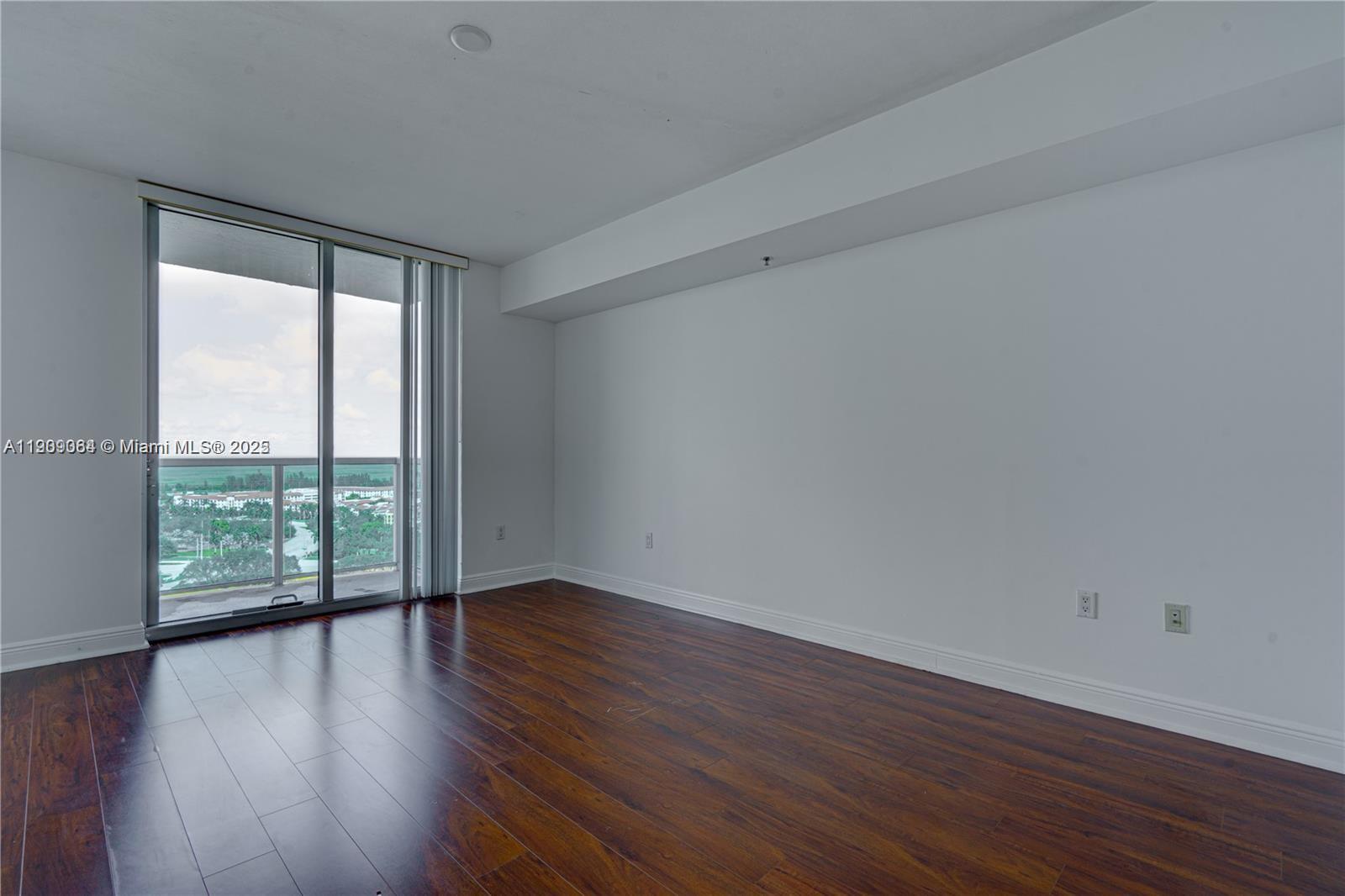 2641 North Flamingo Road, Unit 2307N Sunrise, FL 33323 - Photo 40 of 43 a view of an empty room with wooden floor and a window
