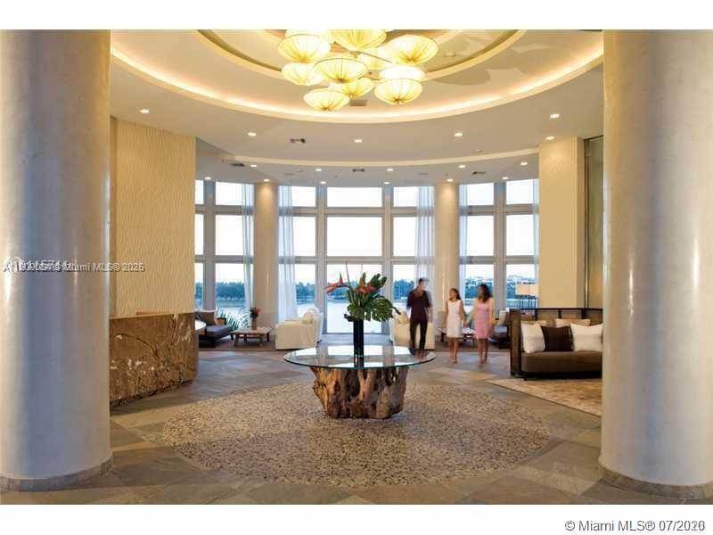 2641 North Flamingo Road, Unit 2307N Sunrise, FL 33323 - Photo 9 of 43 a living room with furniture and a large window