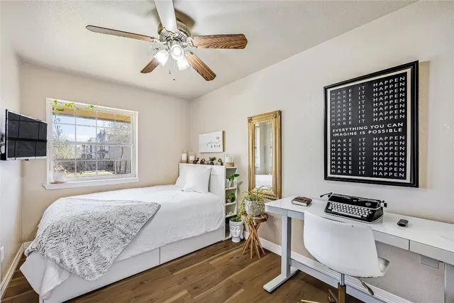 a bedroom with a bed window and a chair