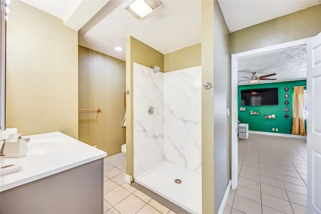 a bathroom with a shower and a sink