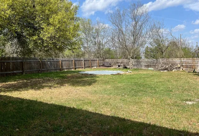 a swimming pool with outdoor space and seating area