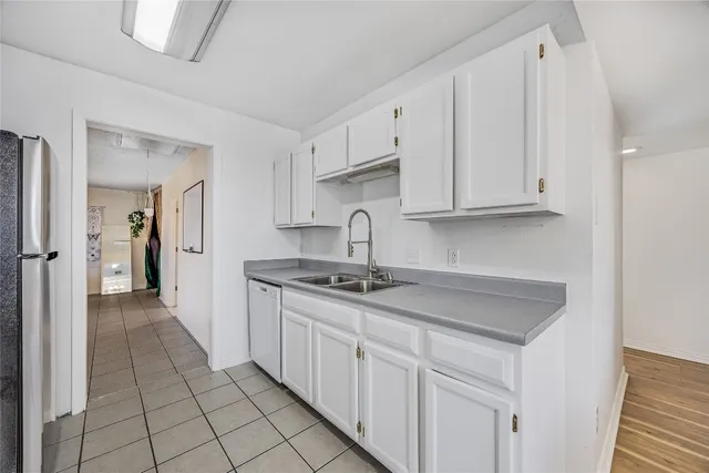 a kitchen with stainless steel appliances granite countertop a sink and cabinets