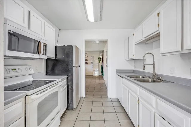 a kitchen with stainless steel appliances granite countertop a stove and a refrigerator