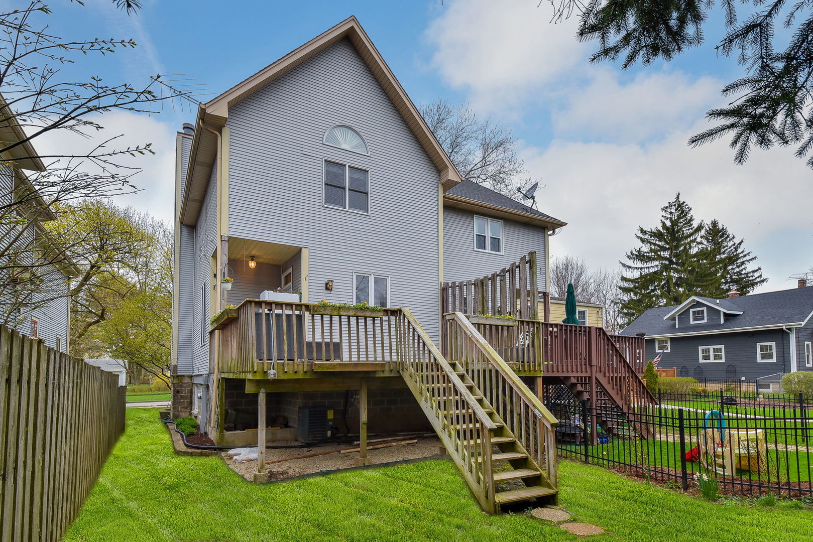 320 North Wright Street Naperville, IL 60540 - Photo 17 of 27 a view of a house with a deck and a yard