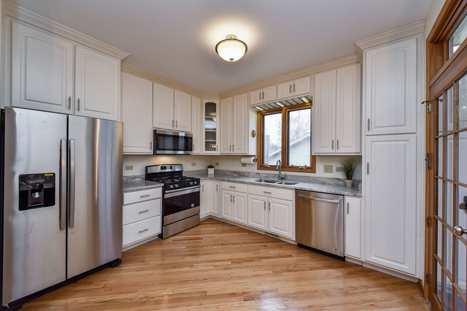 320 North Wright Street Naperville, IL 60540 - Photo 7 of 27 a kitchen with granite countertop a refrigerator stove top oven and sink