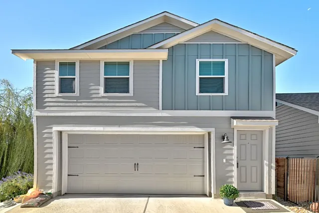 a front view of a house with a garage