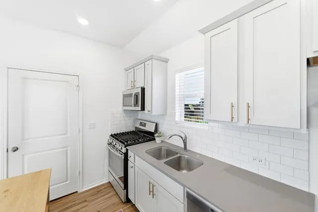 a kitchen with a sink and cabinets