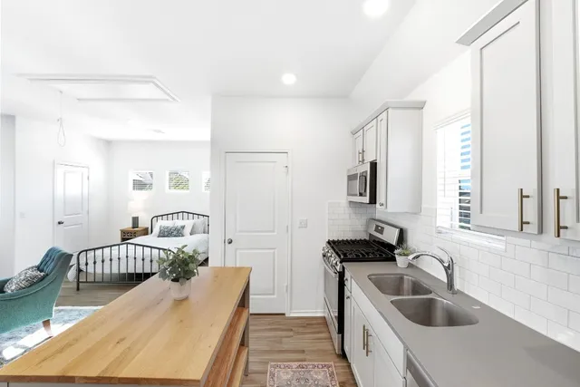 a bedroom with a bed and a sink