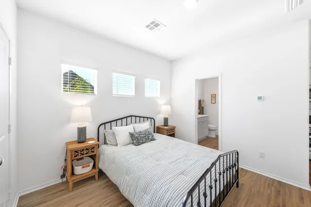 a bedroom with a bed and wooden floor