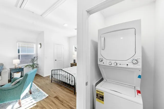 a hall way with furniture a mirror and a rug