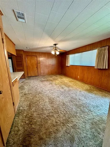 a view of a room with wooden walls