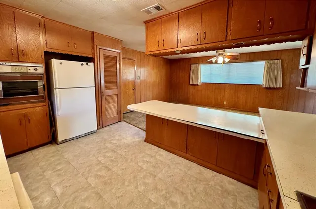 a kitchen with stainless steel appliances a refrigerator and a stove