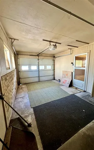 a bedroom with a bed and a window with the outer view