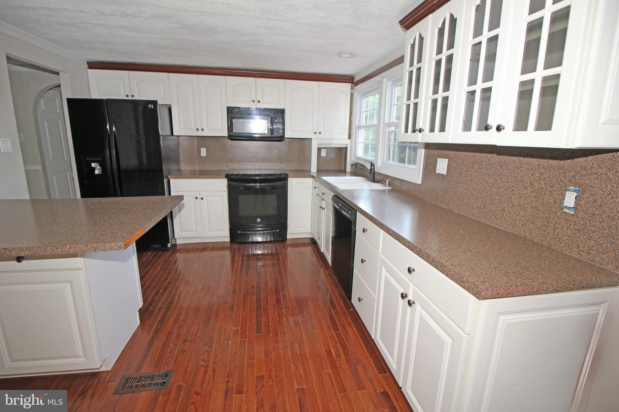 2 Twig Lane Willingboro, NJ 08046 - Photo 9 of 32 a kitchen with stainless steel appliances granite countertop a stove and a wooden floors