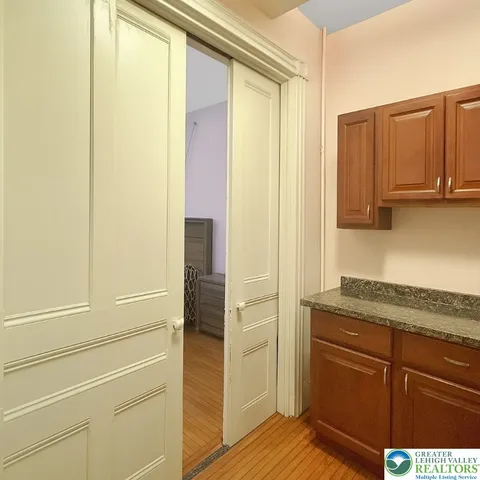 a living room with couch flat screen tv and dresser