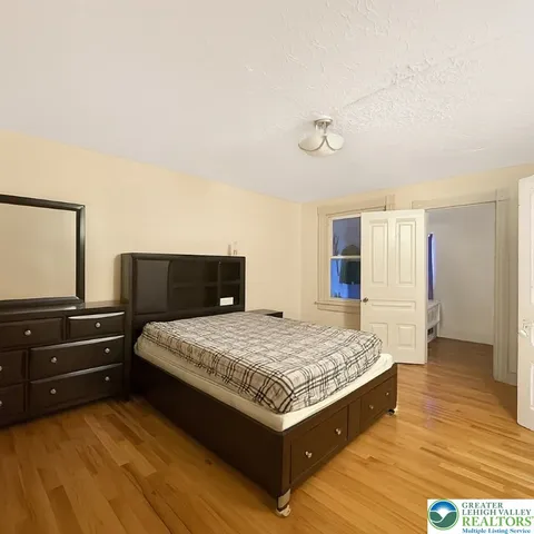 a bedroom with a bed and window