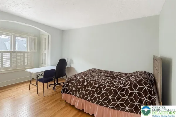 a bedroom with a bed and chair