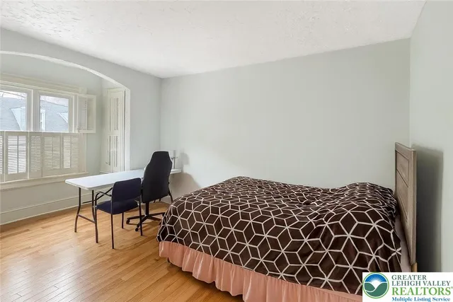 a bedroom with a bed and chair